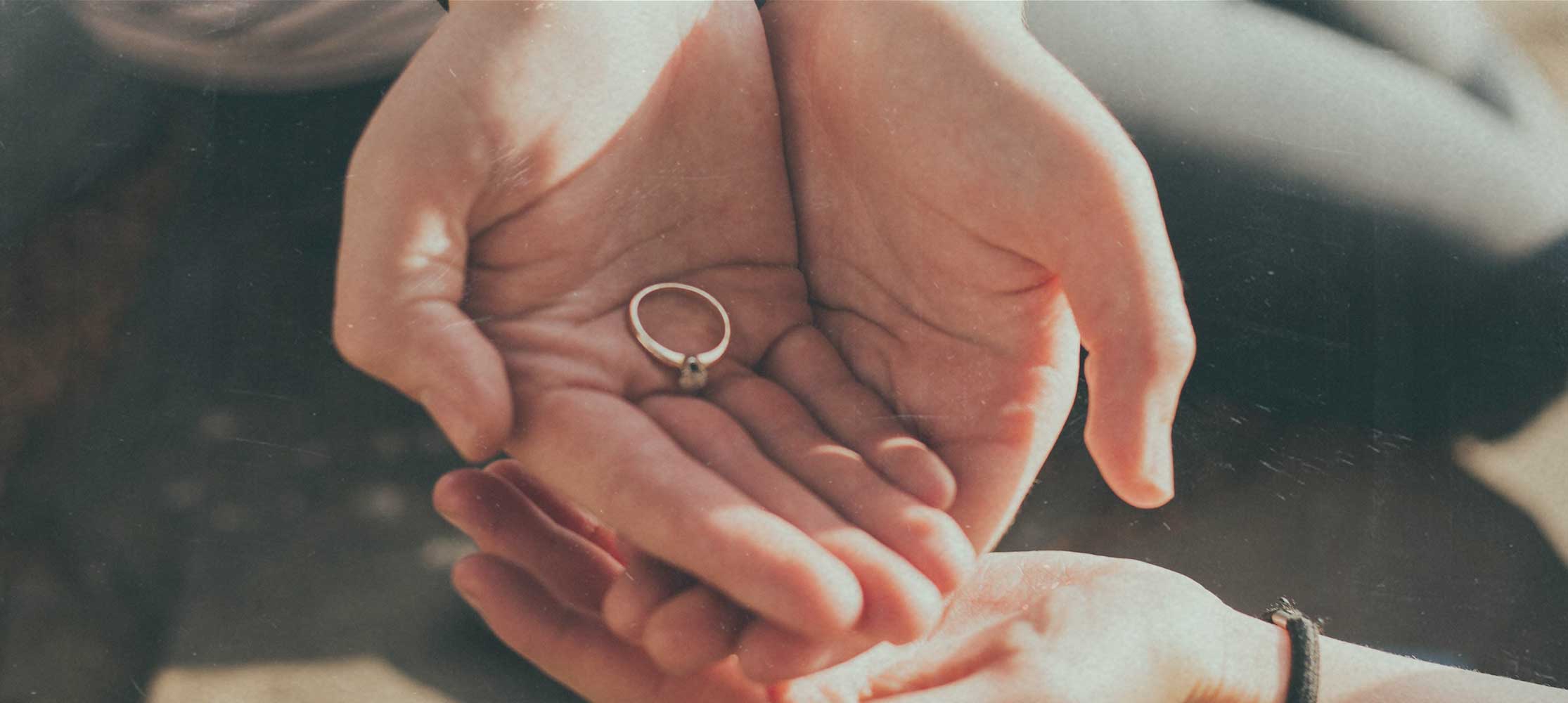 Hände halten Ring Ehe und Partnerschaft